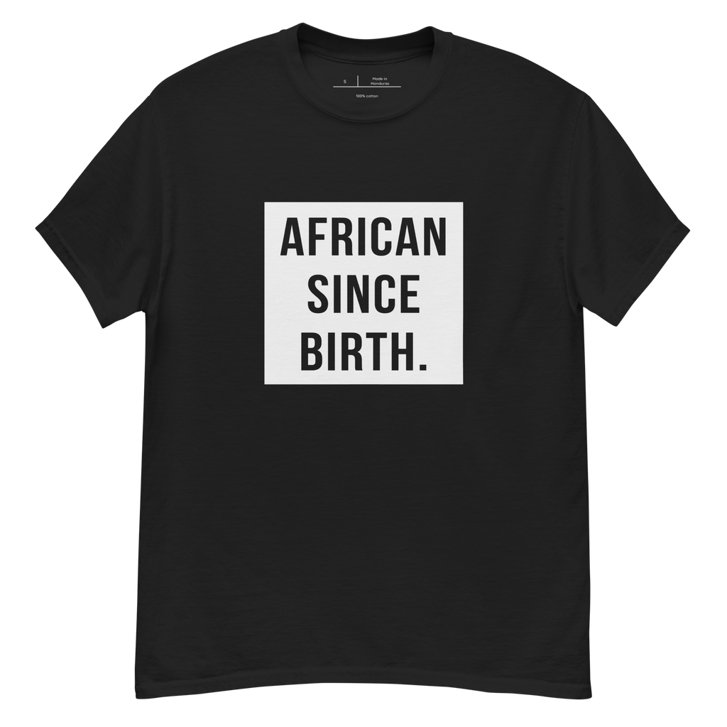 "Dark Black t-shirt with white text that reads 'African Since Birth.' The shirt features a bold font and is perfect for making a statement. The design celebrates African heritage and identity, making it a great choice for anyone who is proud of their roots."