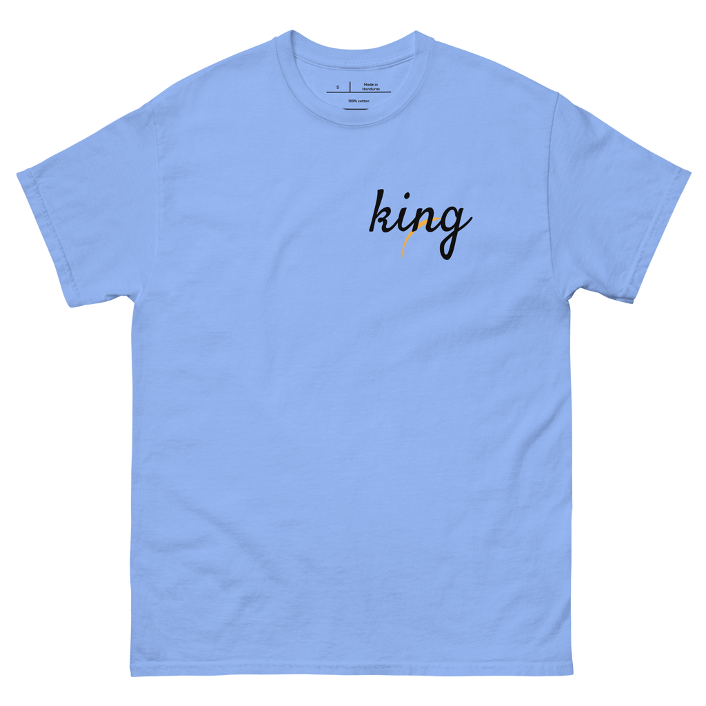 "Natural Blue t-shirt with white text that reads 'KING.' The shirt features a bold font and is perfect for making a statement. The design celebrates African heritage and identity, making it a great choice for anyone who is proud of their roots."