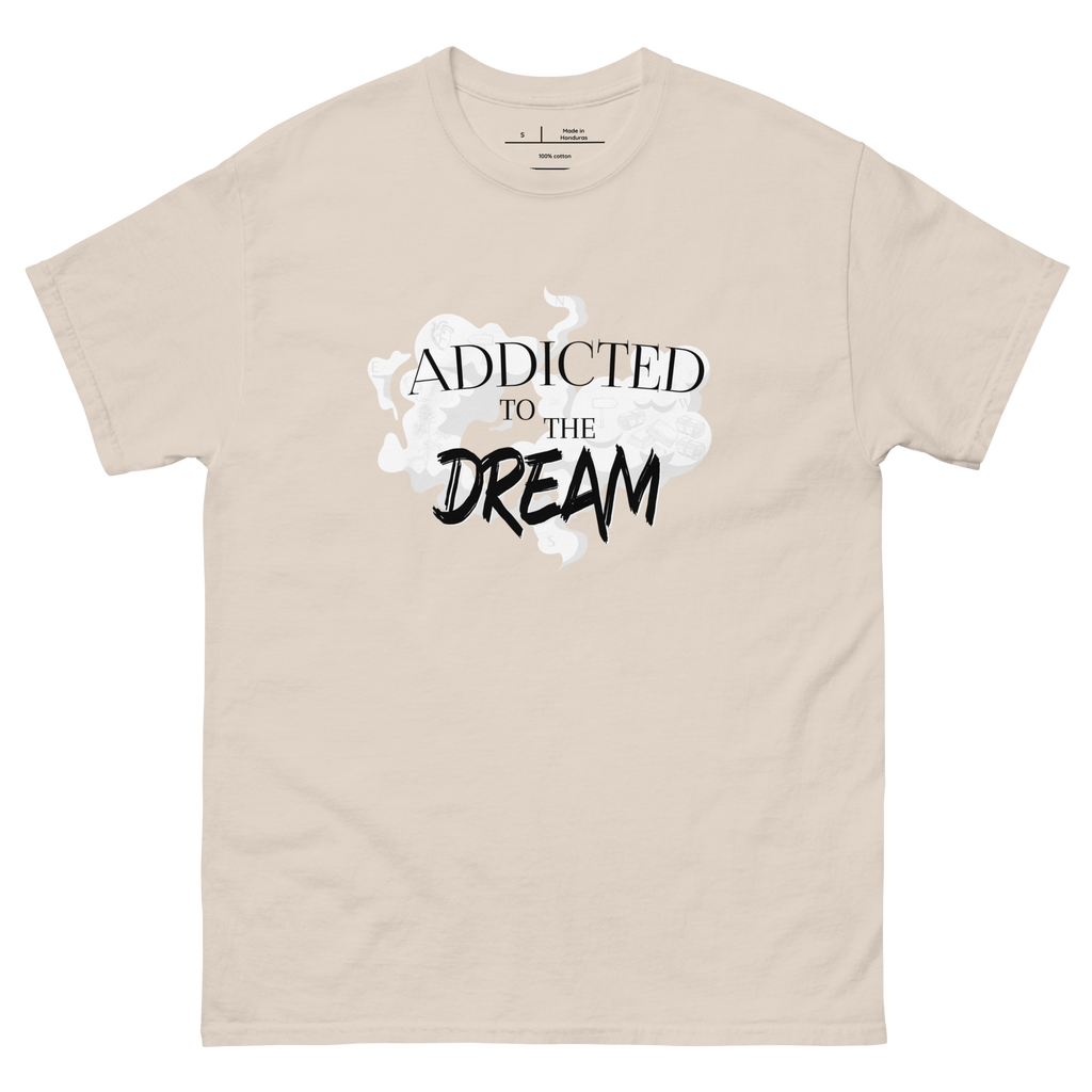 "Tan t-shirt with white text that reads 'Addicted to the Dream.' The shirt features a stylish font and is perfect for casual wear. The design conveys a sense of passion and drive, making it a great choice for anyone who is focused on achieving their goals."