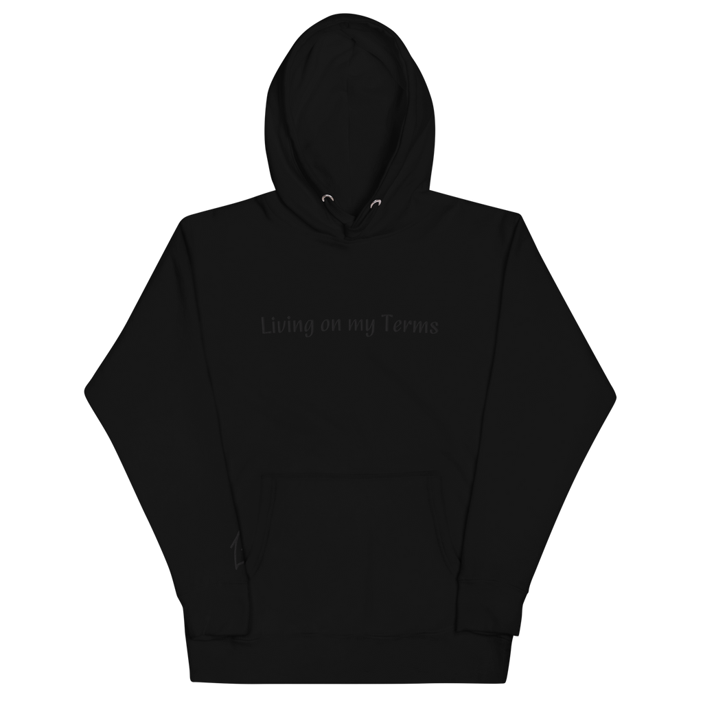 "Black hoodie with Black embroidered text that reads 'Living on my Terms'. The hoodie features a comfortable fit and a bold font. The design conveys a spiritual identity and sense of individuality, making it a great choice for anyone who is not afraid to stand up for what they believe in."